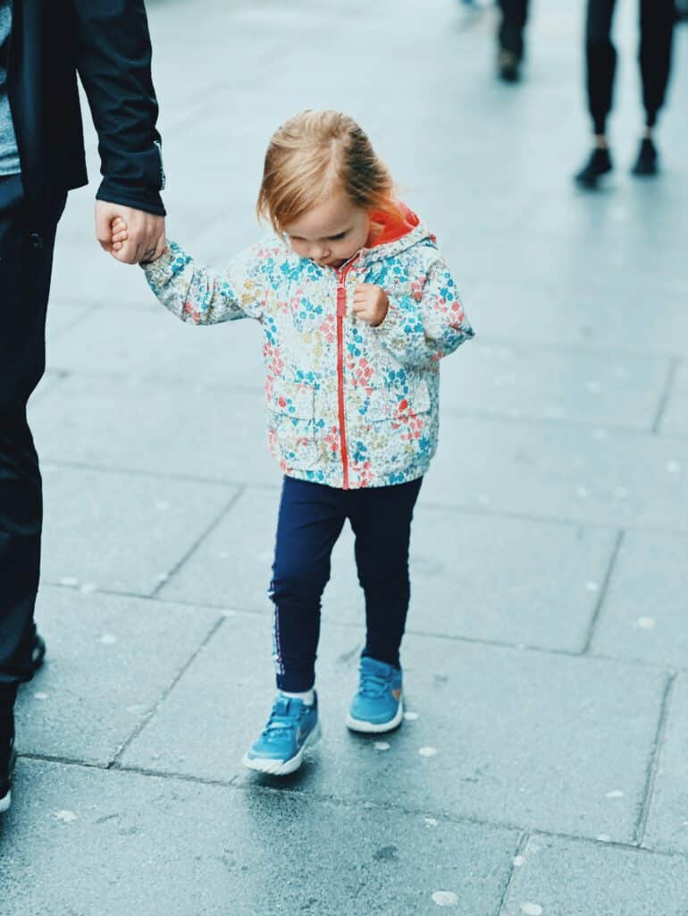 A child holding a parent’s hand on the way – co-parenting after separation